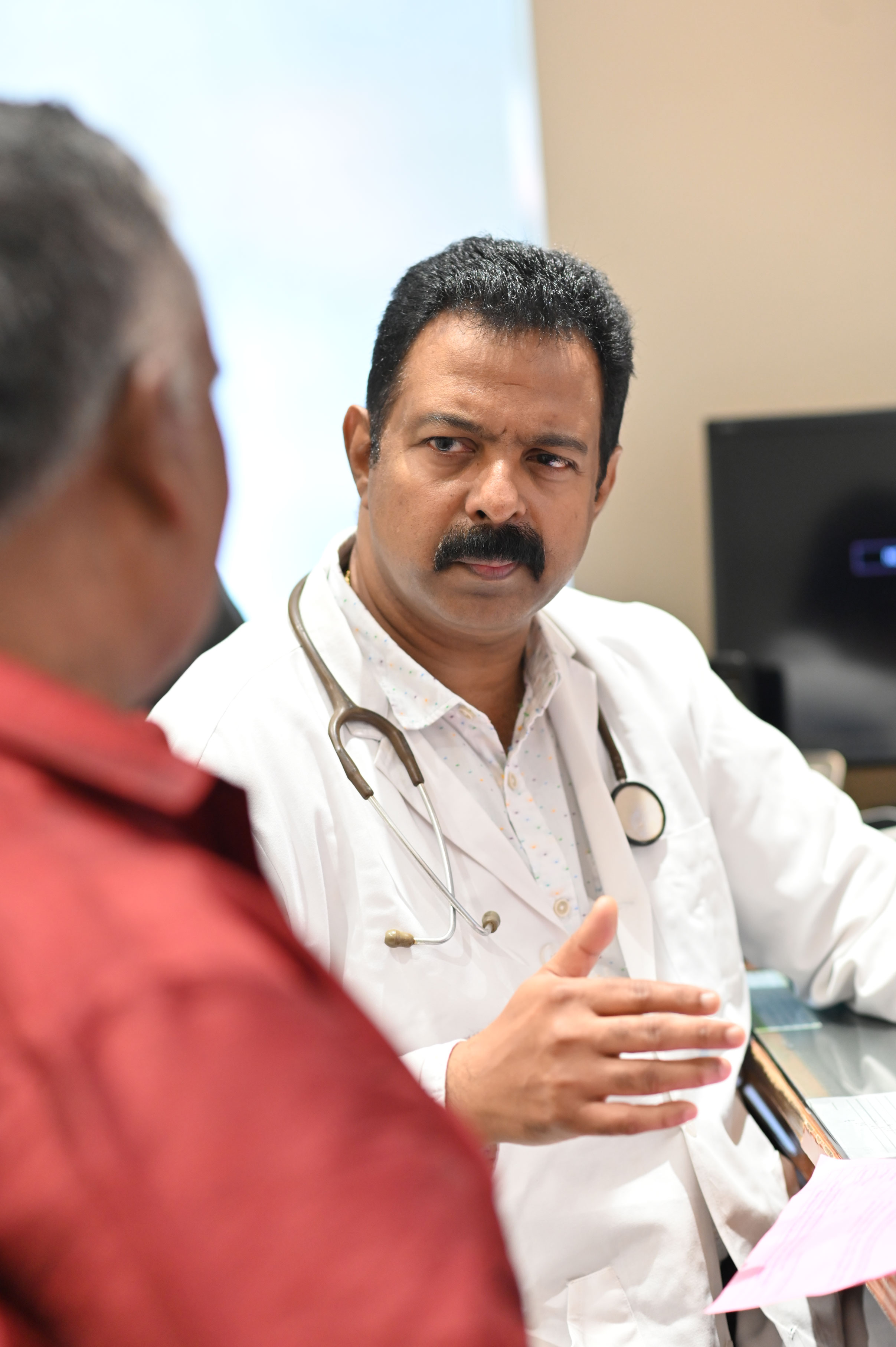 Dr.Isaac Sunder Sen Speaking with Patient